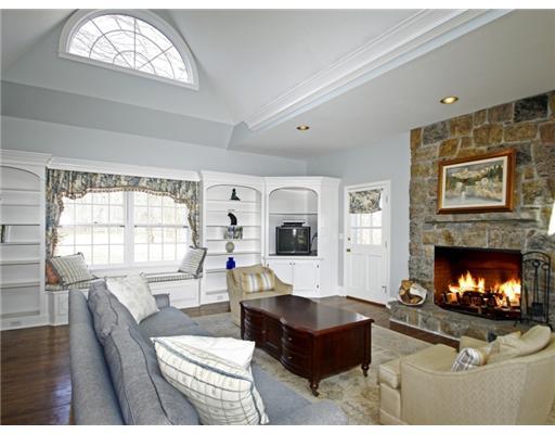 292 Brushy Ridge Road New Canaan, CT 06840 - Photo 7 of 16 a living room with furniture a fireplace and a large window