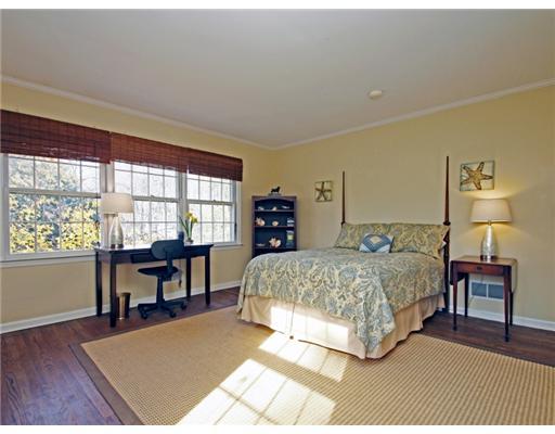 292 Brushy Ridge Road New Canaan, CT 06840 - Photo 10 of 16 a bedroom with a bed table and two windows