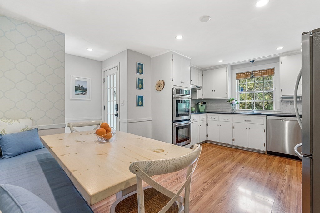 104 Westgate Wellesley, MA 02481 - Photo 12 of 31 a kitchen with stainless steel appliances a refrigerator a sink a stove a dining table and chairs