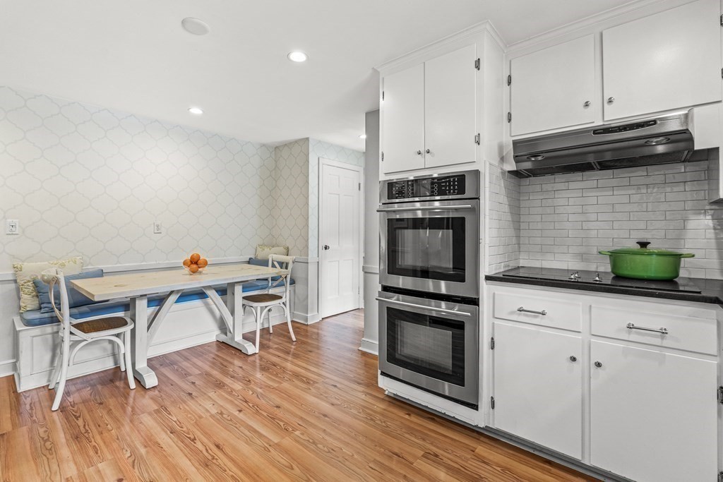 104 Westgate Wellesley, MA 02481 - Photo 13 of 31 a kitchen with stainless steel appliances a stove a microwave a sink a refrigerator dining table and chairs
