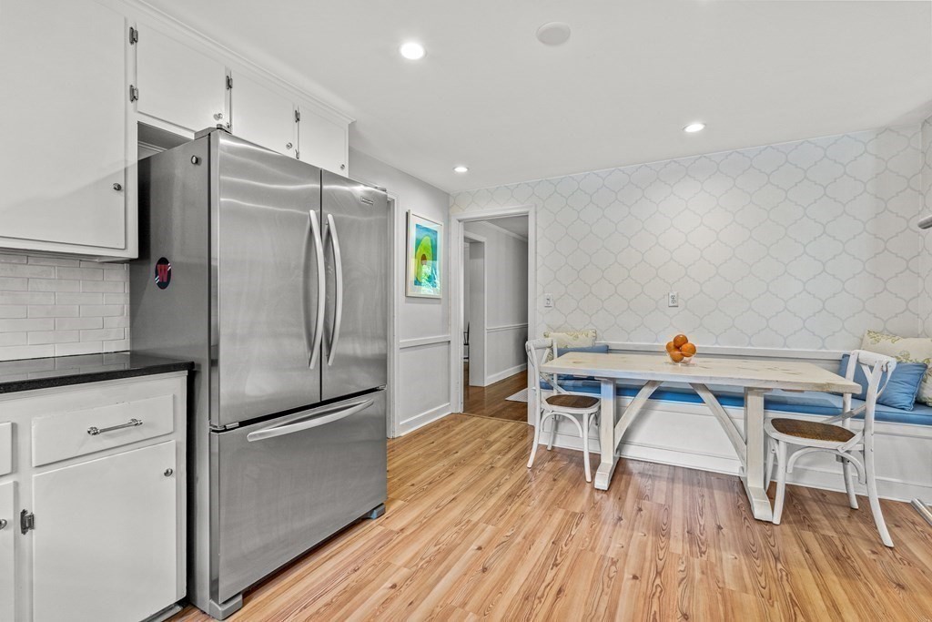 104 Westgate Wellesley, MA 02481 - Photo 14 of 31 a kitchen with stainless steel appliances a refrigerator and a wooden floor