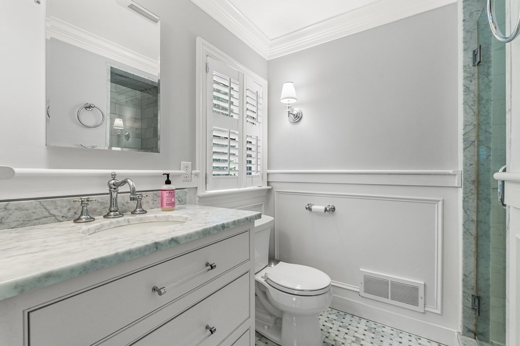 104 Westgate Wellesley, MA 02481 - Photo 20 of 31 a bathroom with a granite countertop sink a toilet and a mirror