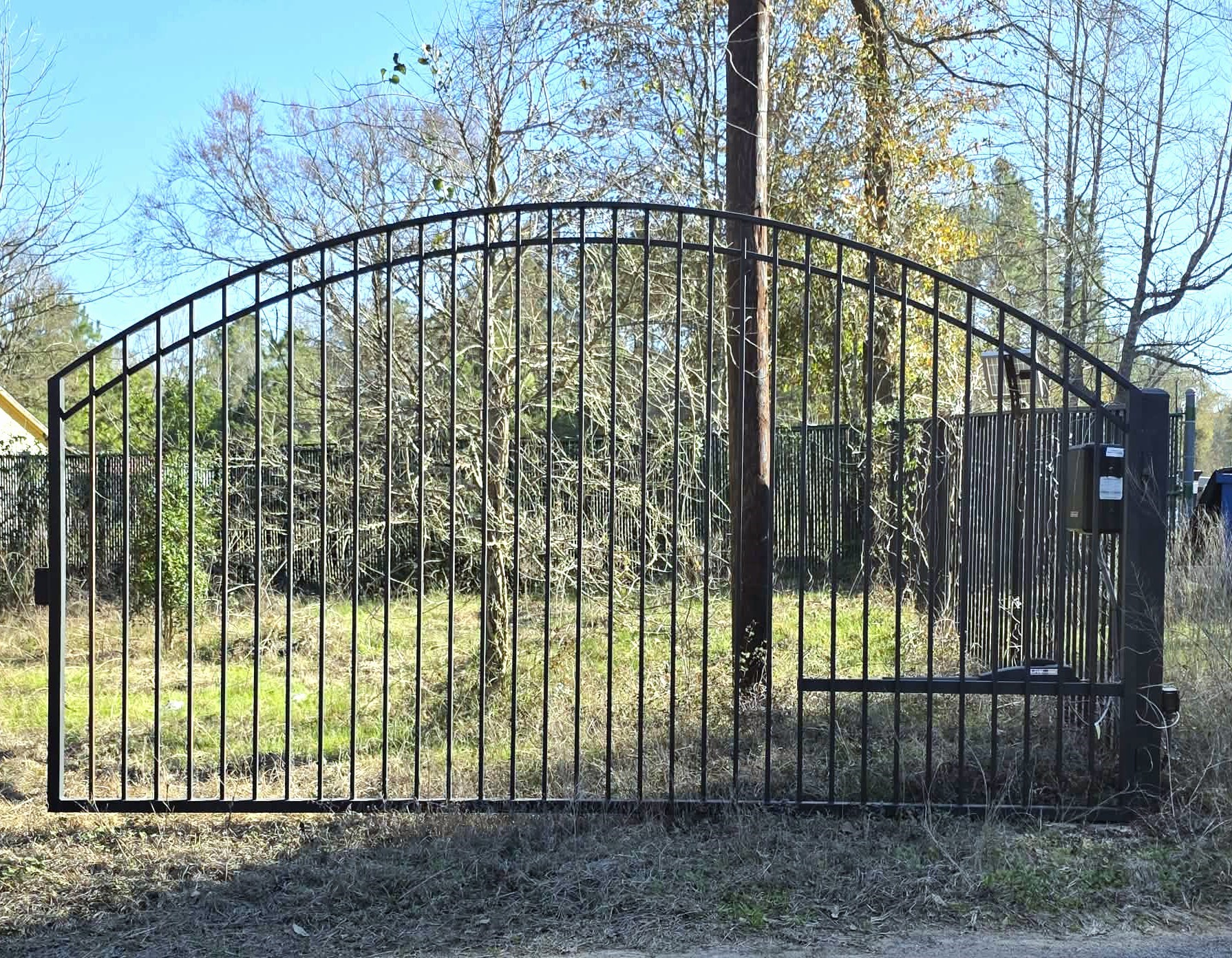 2220 Lee Turner Road Cleveland, TX 77328 - Photo 3 of 15 A gorgeous iron gate and fence frames the front of your 1.46 acres from the road.