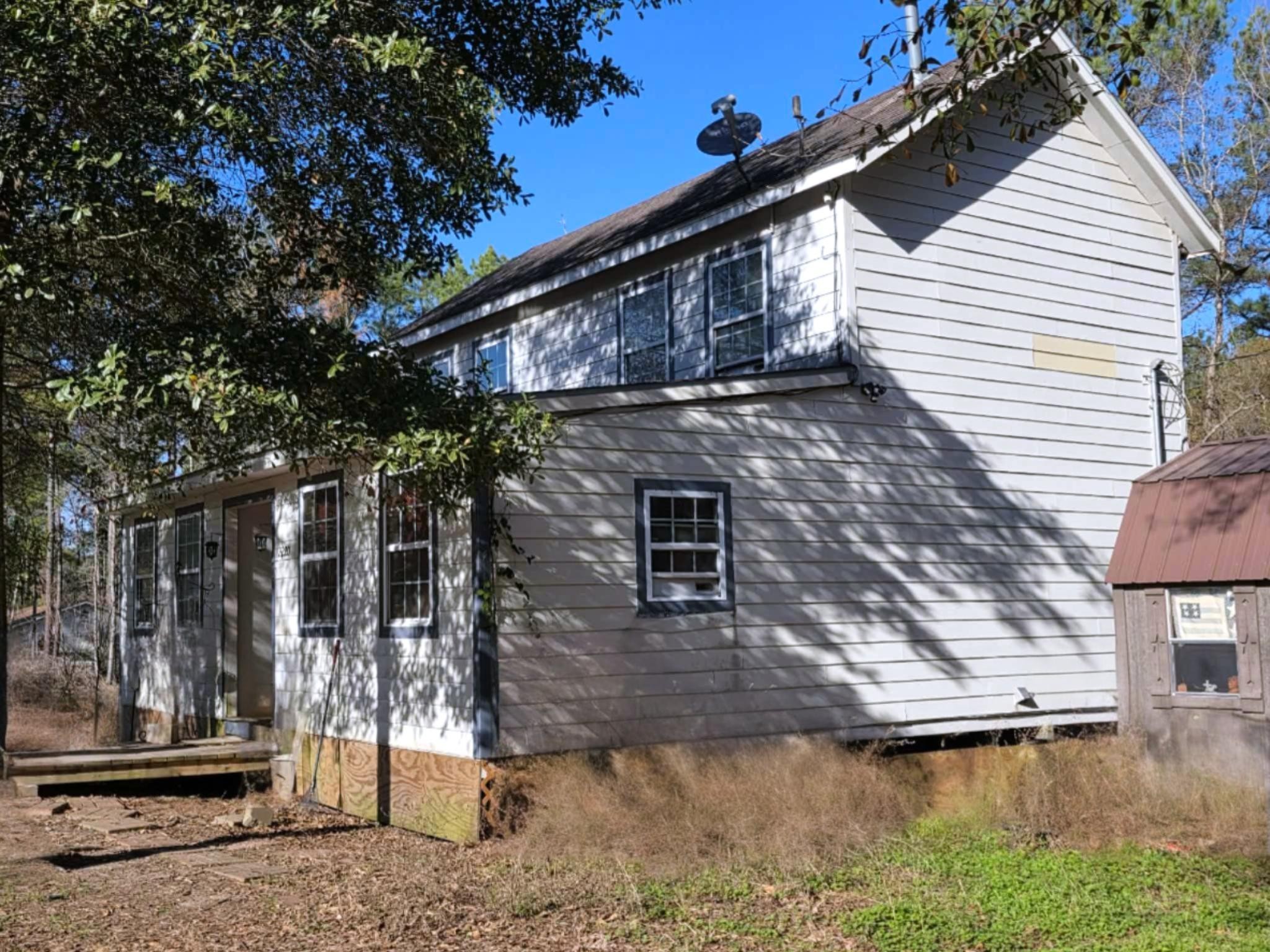 2220 Lee Turner Road Cleveland, TX 77328 - Photo 8 of 15 A side view of the south side of the home near the storage building. Two very large bedrooms and a full bath are upstairs.