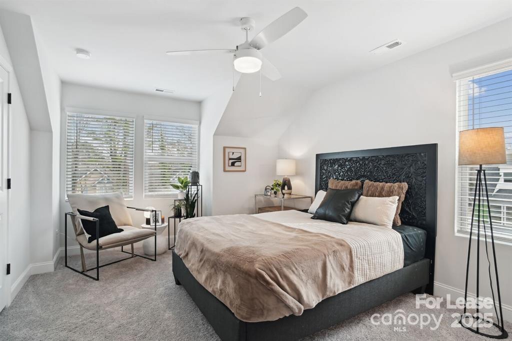6134 Wilora Lake Road Charlotte, NC 28212 - Photo 11 of 21 a bedroom with a bed and a large window