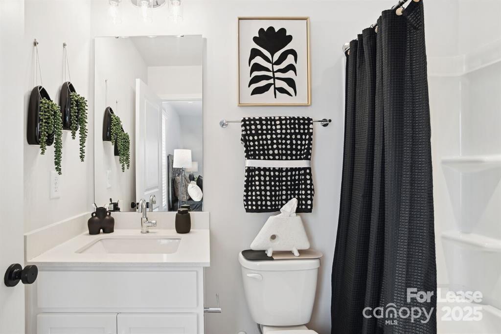 6134 Wilora Lake Road Charlotte, NC 28212 - Photo 16 of 21 a bathroom with a sink and mirror