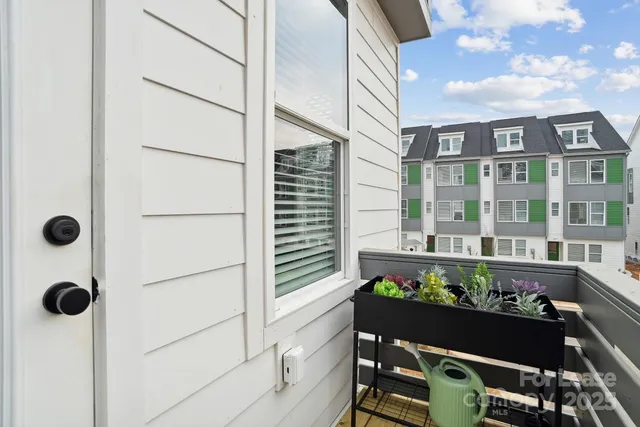 a view of a chairs and table in the balcony