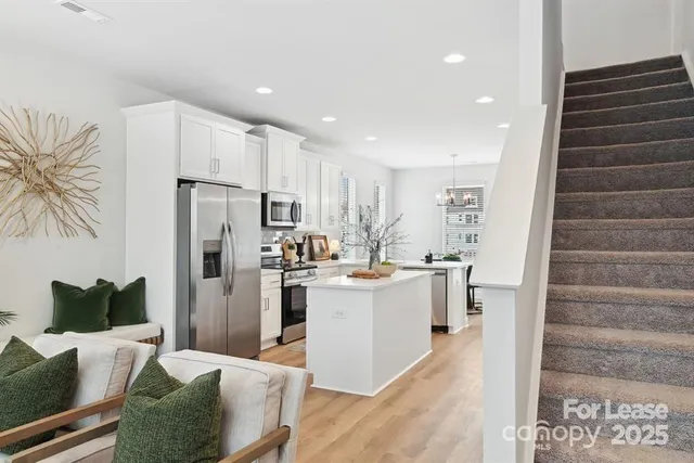 a kitchen with refrigerator and cabinets