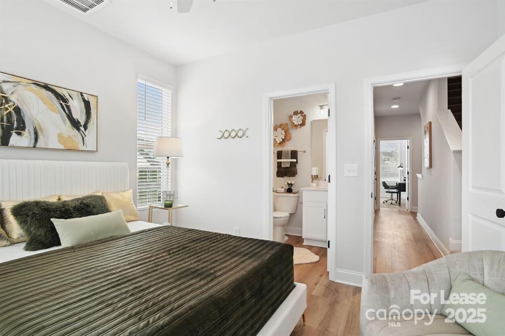 6134 Wilora Lake Road Charlotte, NC 28212 - Photo 5 of 21 a bedroom with a bed and a couch