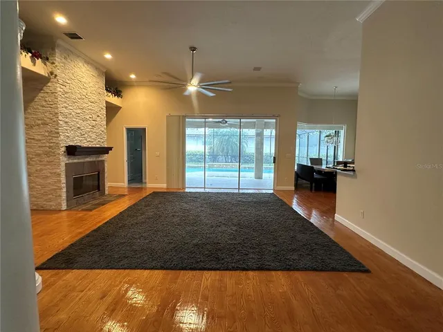 a kitchen with granite countertop a refrigerator a sink a stove and cabinets