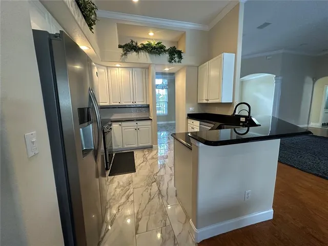 a kitchen with stainless steel appliances a refrigerator sink and stove