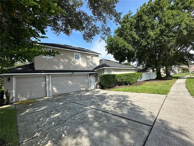 a front view of a house with a yard and a garage