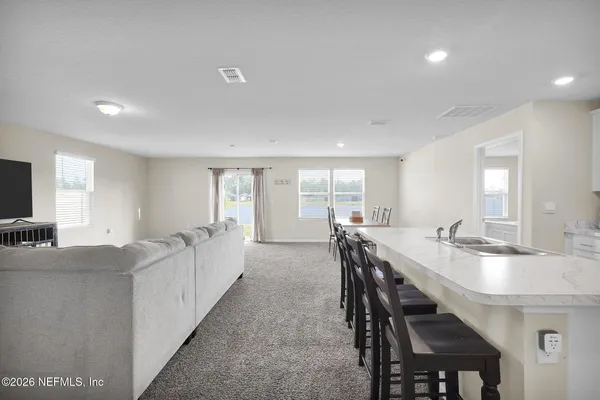 a view of a dining room and livingroom with furniture window and wooden floor
