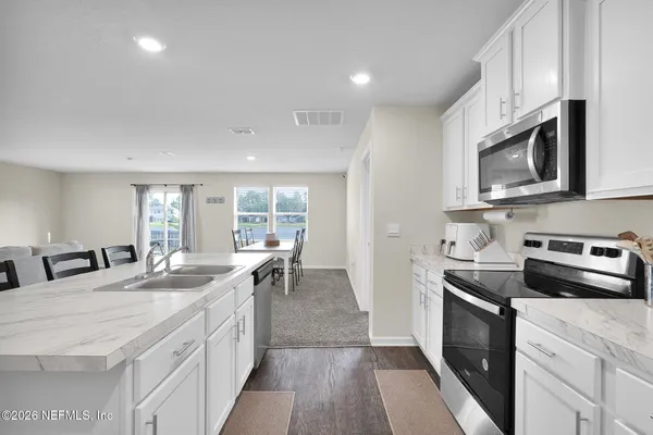 a kitchen with stainless steel appliances granite countertop a sink and stove top oven