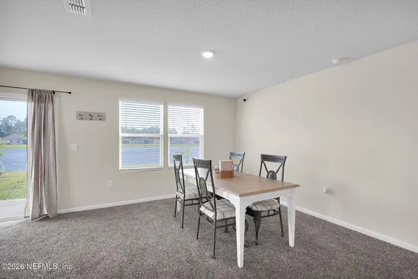 a dining room with furniture and window