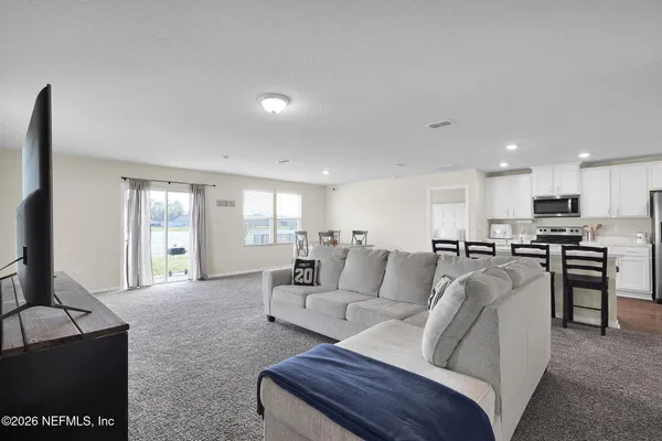 a living room with furniture and a large window