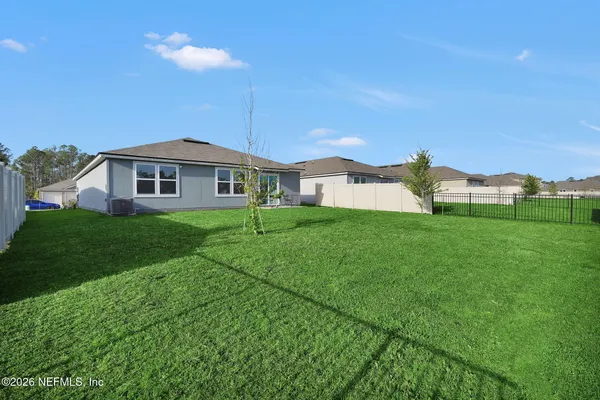 a view of a house with a yard and deck