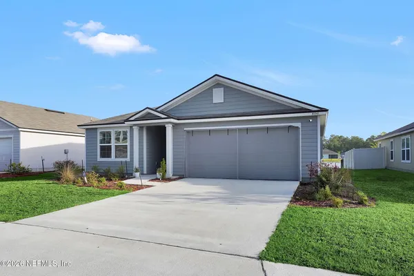 a front view of a house with a yard and garage