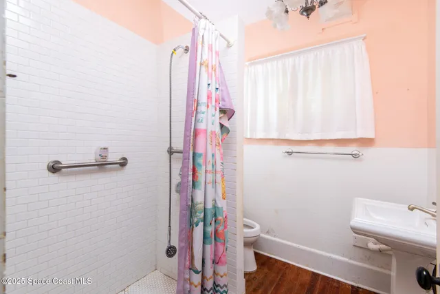 a bathroom with a sink and a shower curtain