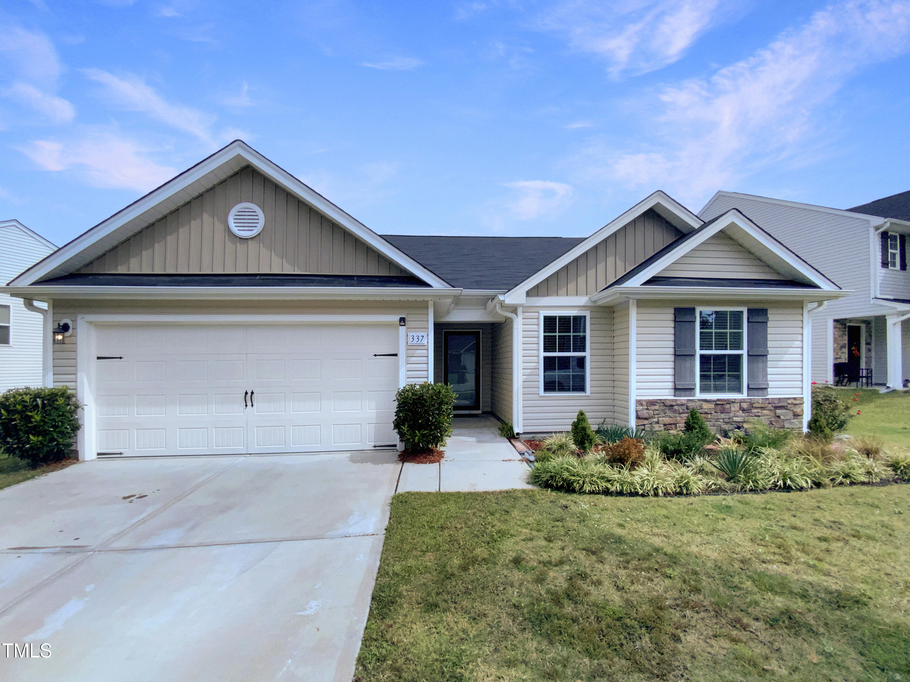 337 Rustling Way Zebulon, NC 27597 - Photo 1 of 19 a front view of a house with garden