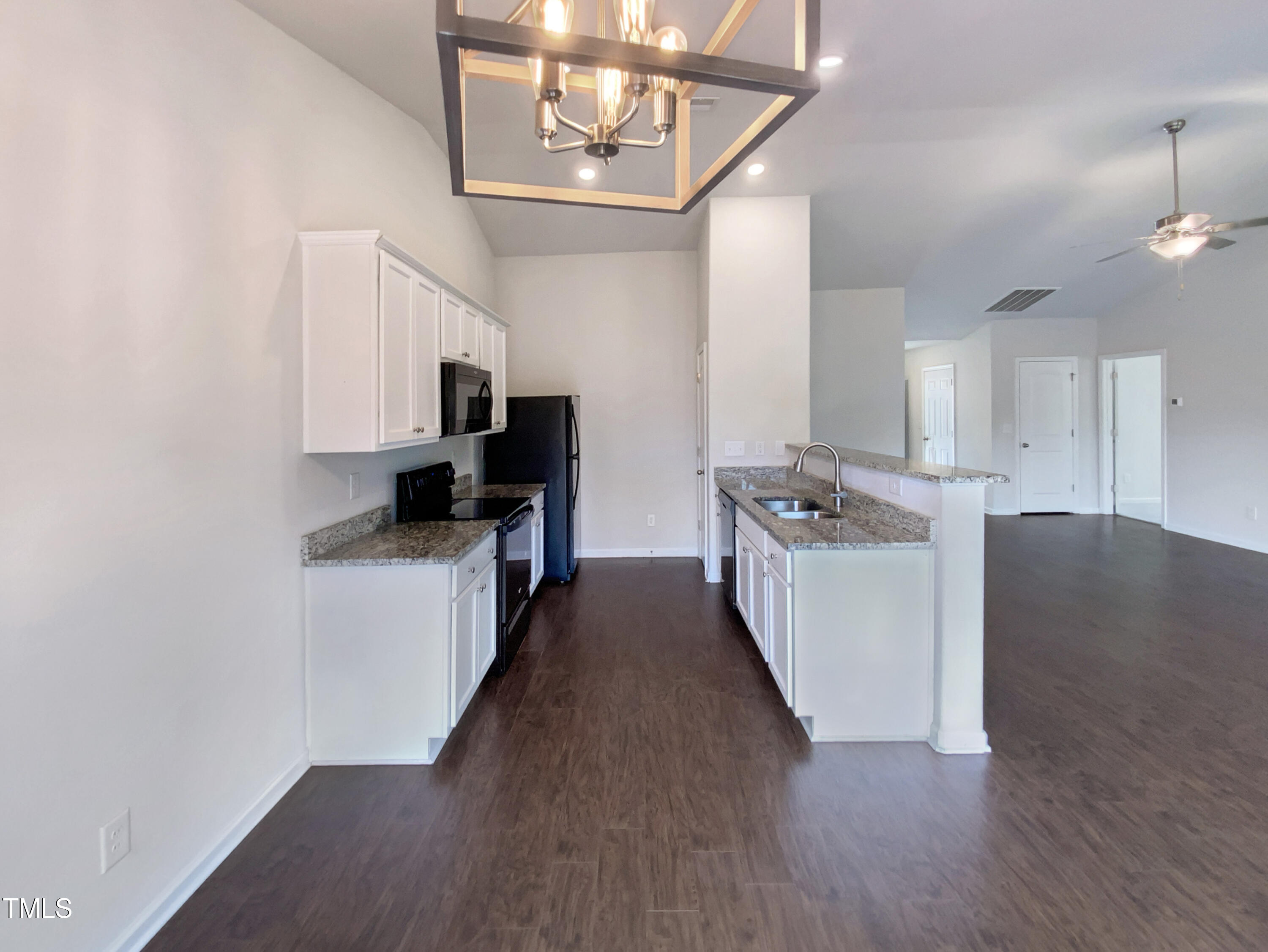 337 Rustling Way Zebulon, NC 27597 - Photo 11 of 19 a kitchen with kitchen island granite countertop a sink cabinets and stainless steel appliances