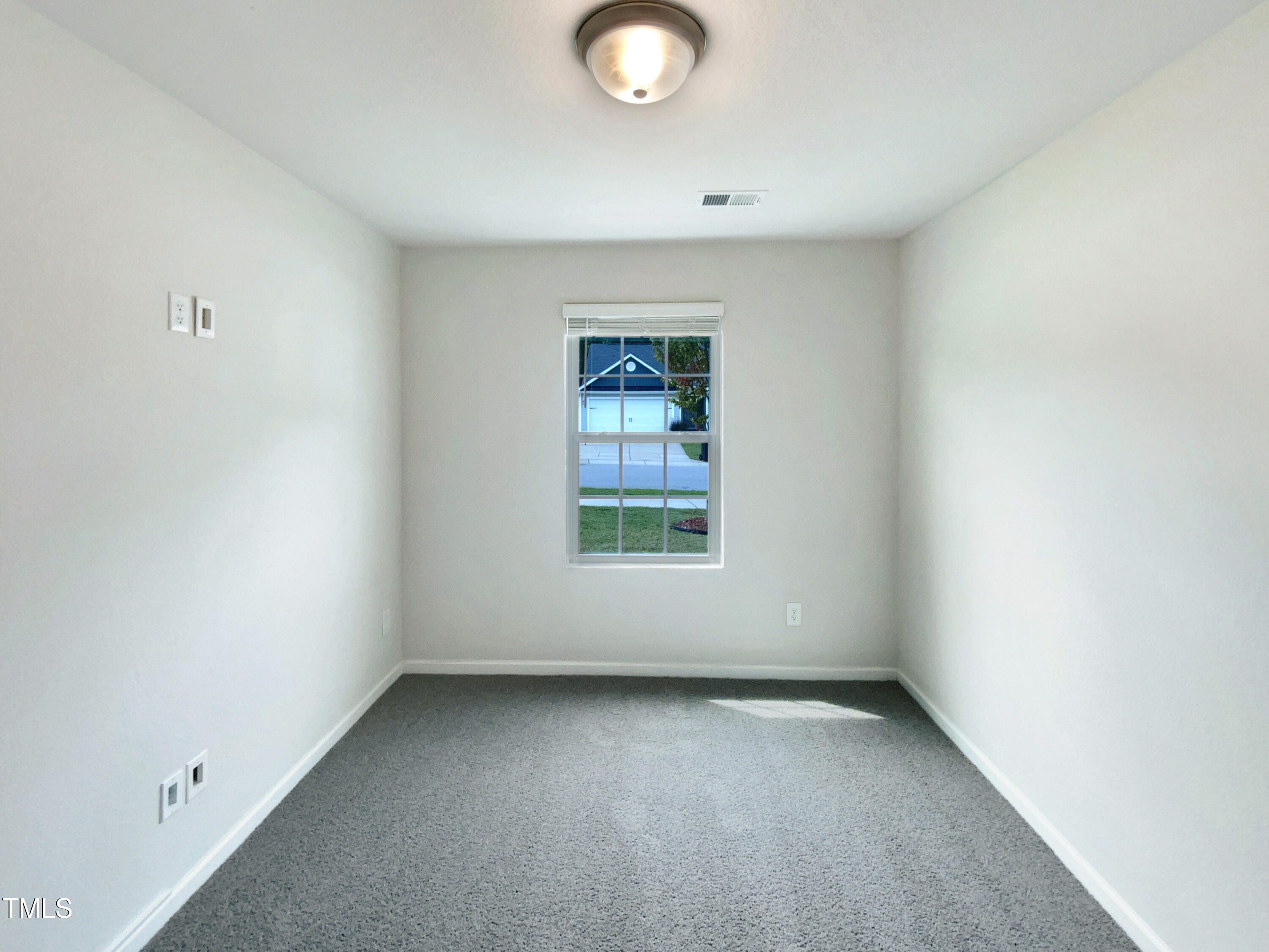 337 Rustling Way Zebulon, NC 27597 - Photo 13 of 19 a view of a window in an empty room