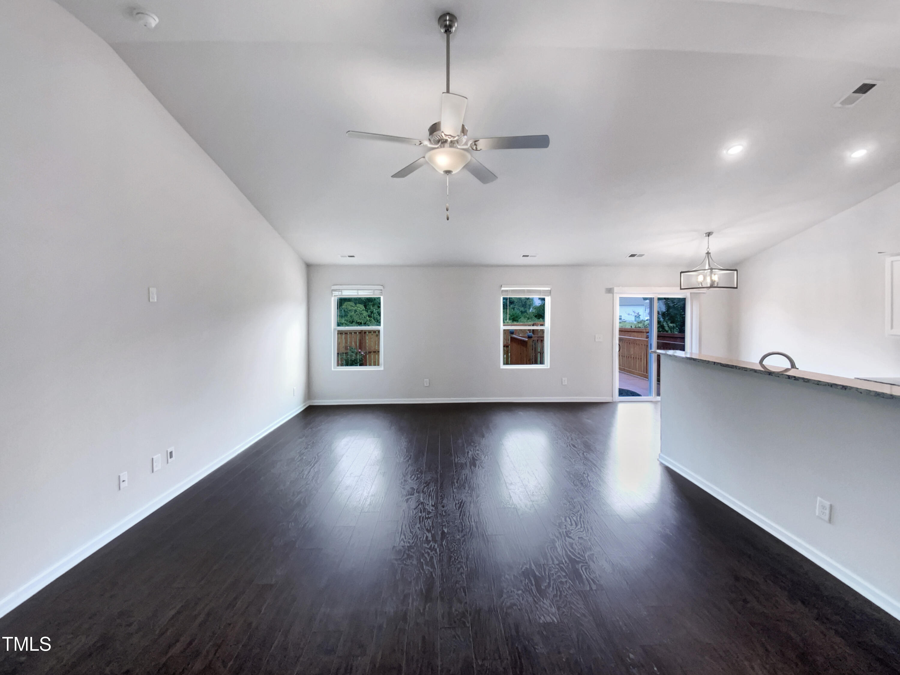 337 Rustling Way Zebulon, NC 27597 - Photo 9 of 19 an empty room with wooden floor and windows