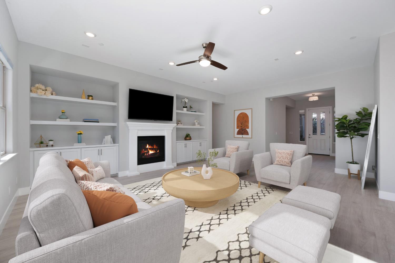a living room with furniture a flat screen tv and a fireplace