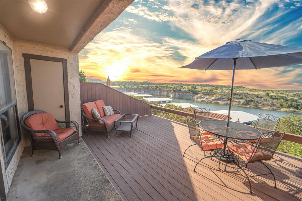 a view of a balcony with furniture and umbrella