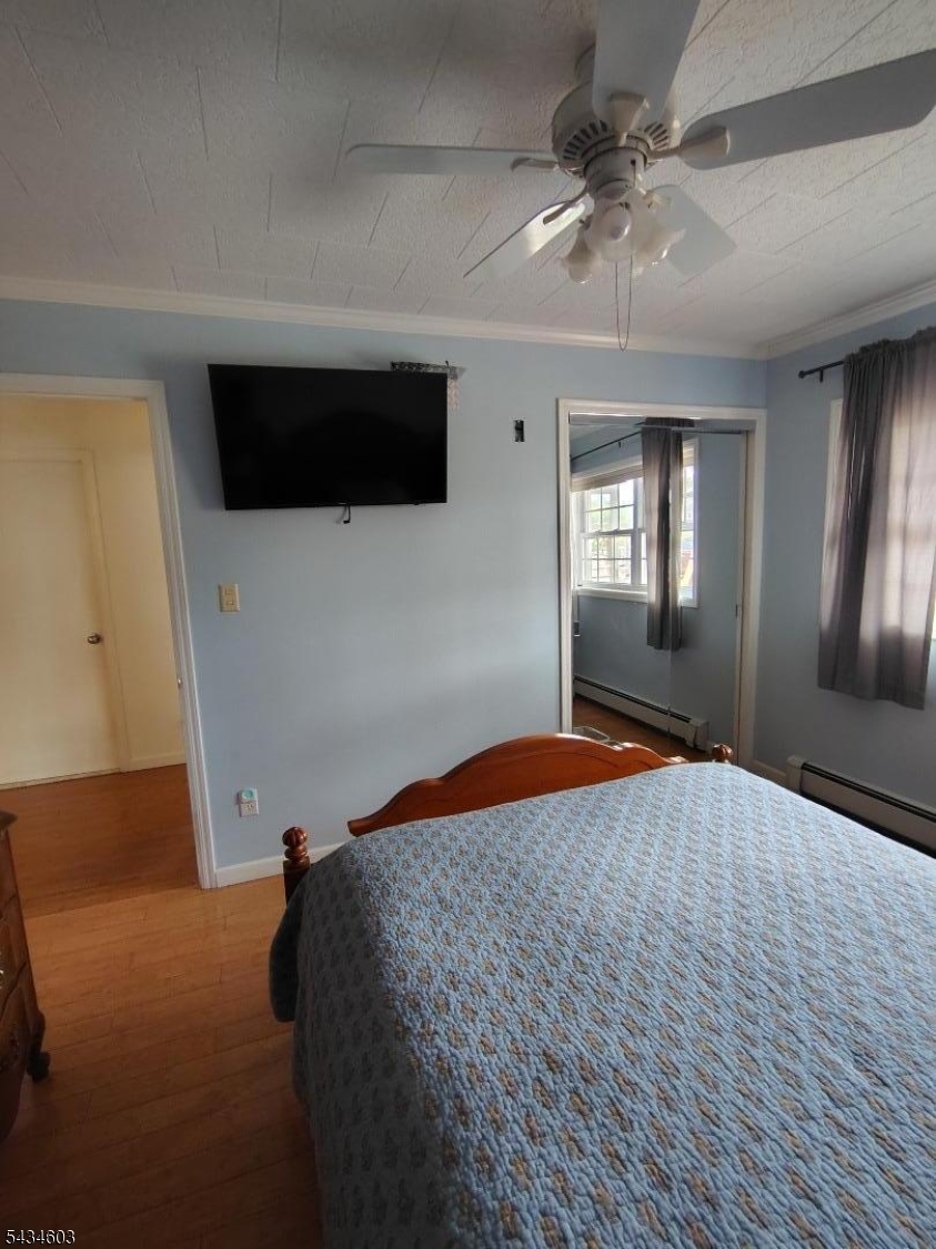 442 River Road North Arlington, NJ 07031 - Photo 13 of 26 a bedroom with a bed and a chandelier