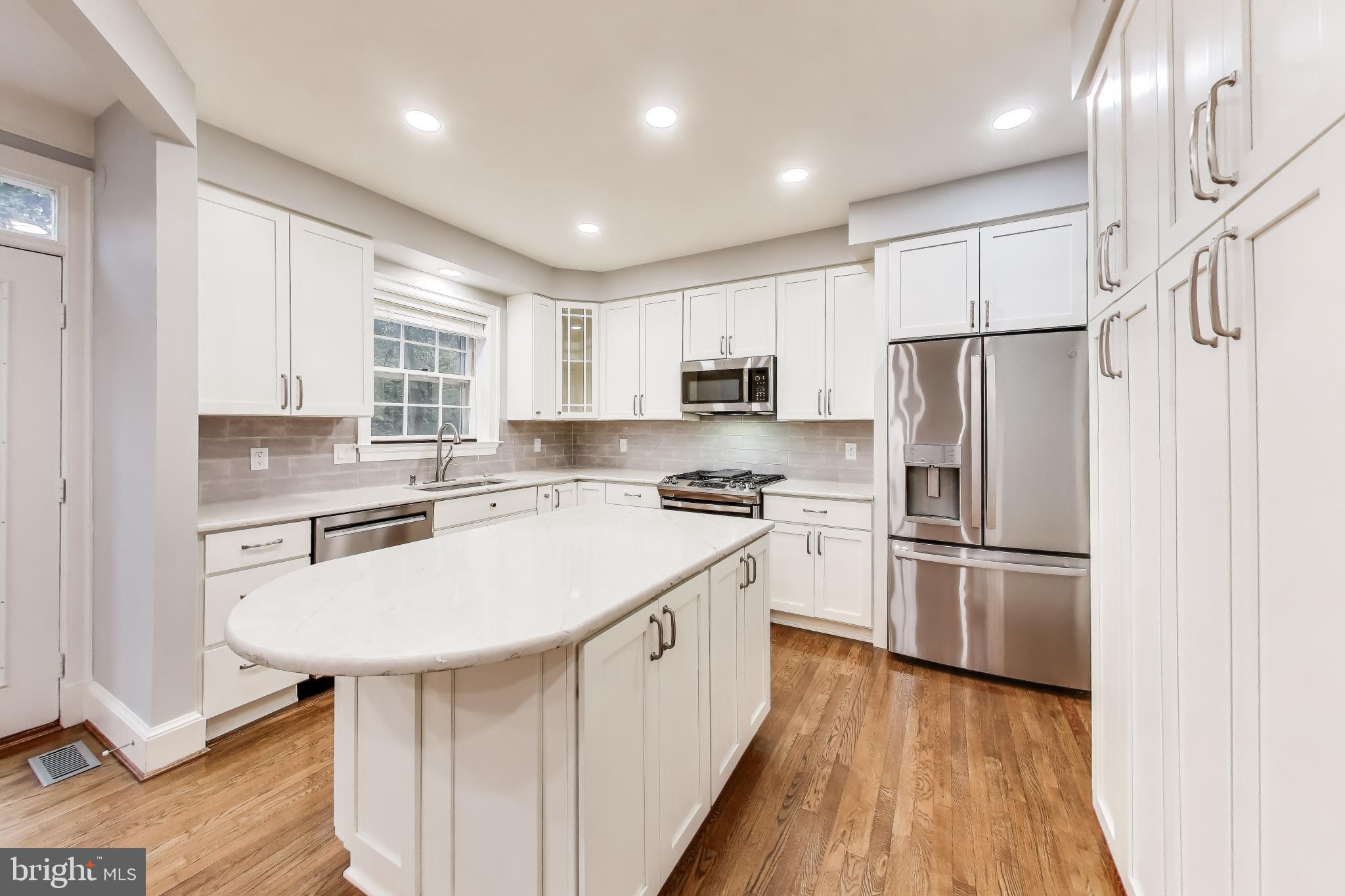 8017 Rising Ridge Road Bethesda, MD 20817 - Photo 11 of 54 a kitchen with a refrigerator a sink and a stove top oven