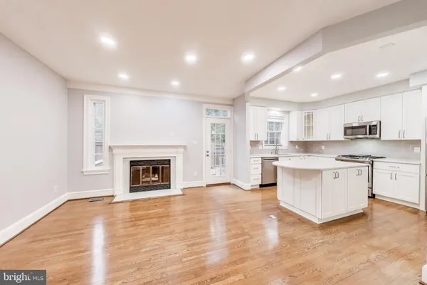 a view of kitchen with granite countertop stove top oven and cabinets