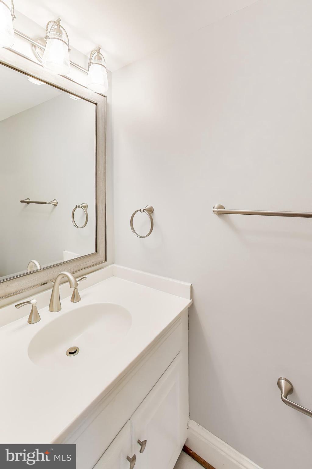 8017 Rising Ridge Road Bethesda, MD 20817 - Photo 16 of 54 a bathroom with a sink and a mirror