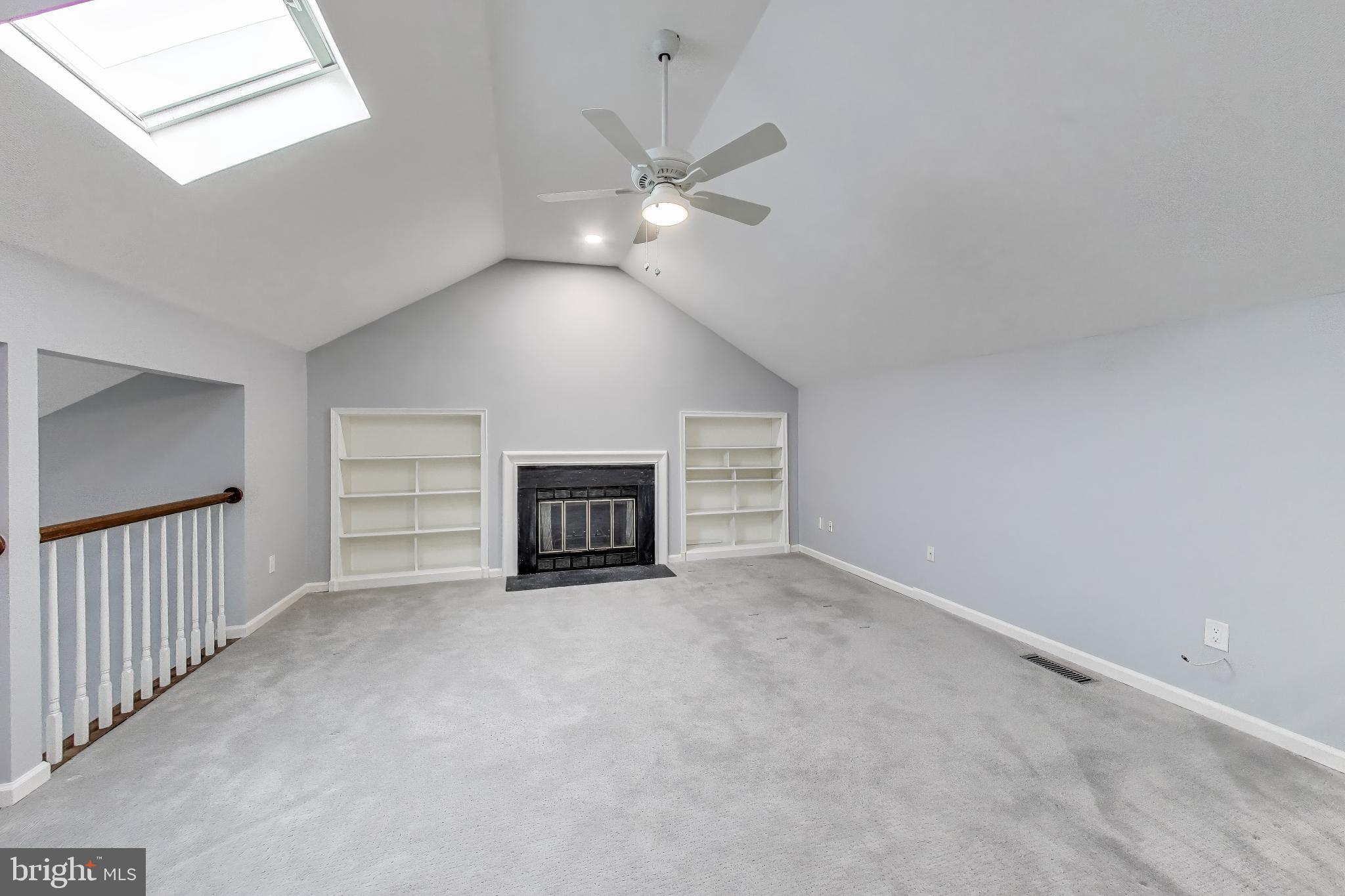 8017 Rising Ridge Road Bethesda, MD 20817 - Photo 20 of 54 an empty room with fireplace and fan
