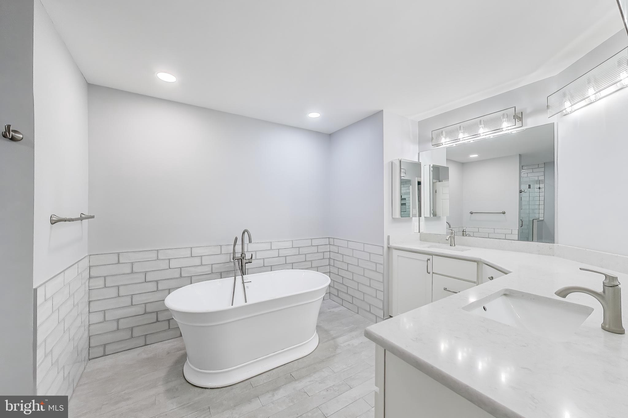 8017 Rising Ridge Road Bethesda, MD 20817 - Photo 23 of 54 a bathroom with a sink a bathtub a mirror and vanity