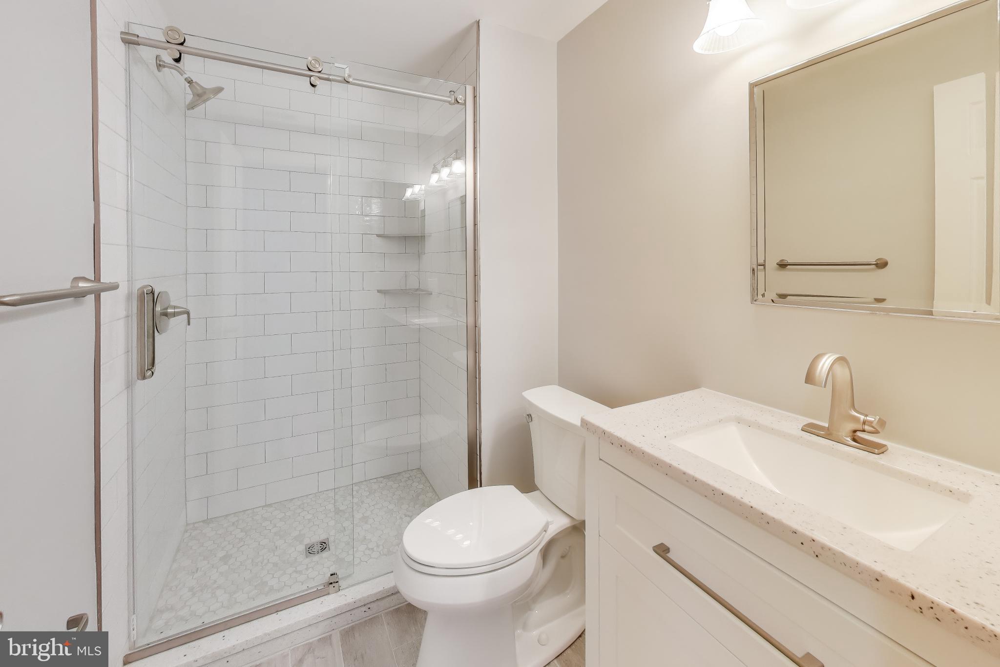 8017 Rising Ridge Road Bethesda, MD 20817 - Photo 44 of 54 a bathroom with a sink toilet and shower