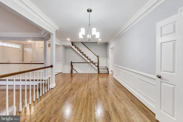 a view of entryway and hall with wooden floor
