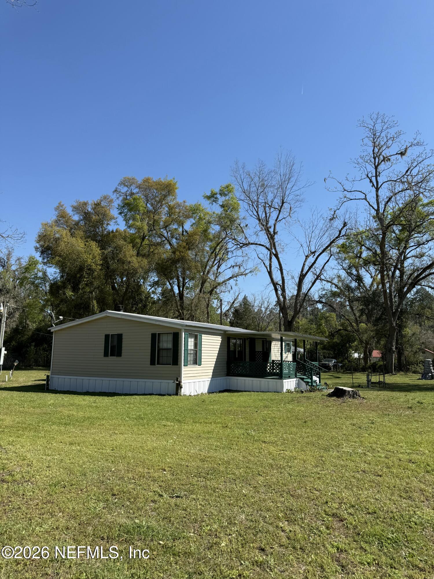 7452 129th Road Live Oak, FL 32060 - Photo 2 of 15 a front view of a house with a yard
