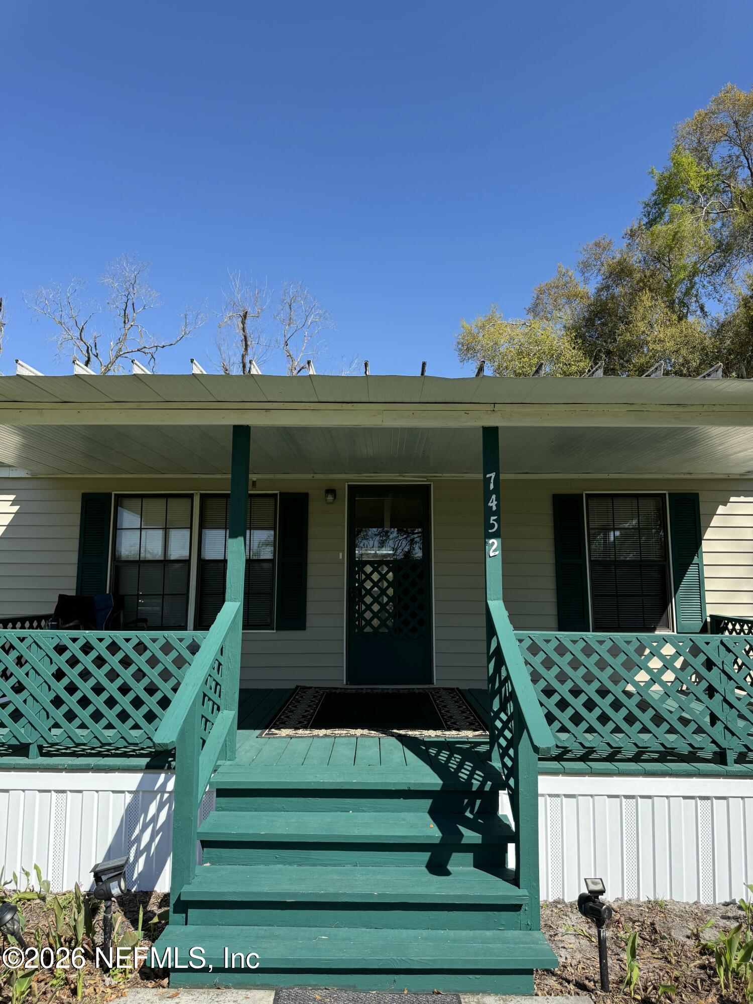 7452 129th Road Live Oak, FL 32060 - Photo 3 of 15 a front view of a house with a garden