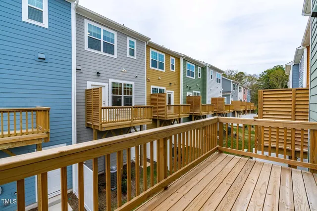 a view of a balcony with wooden floor and fence