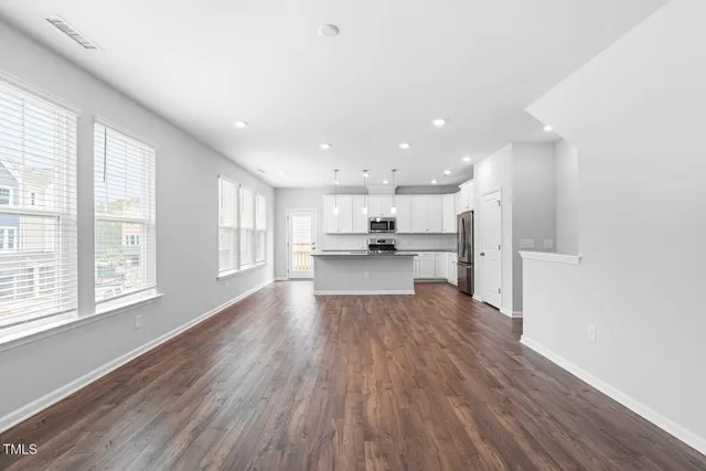 a view of kitchen with wooden floor and windows