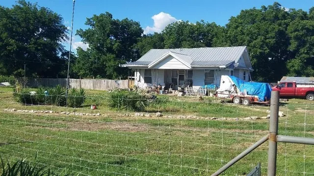 a backyard of a house with yard and outdoor seating