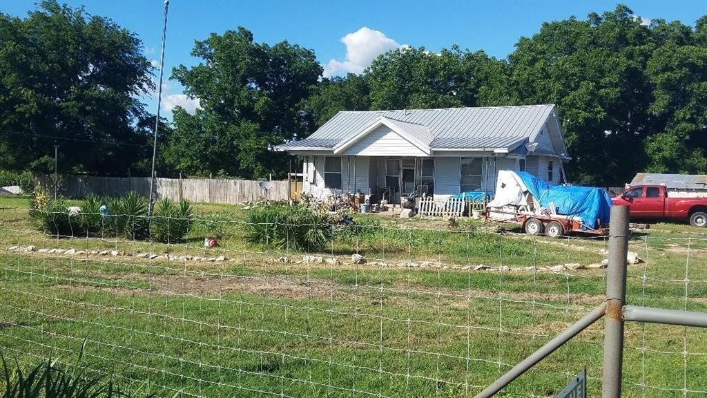 a backyard of a house with yard and outdoor seating