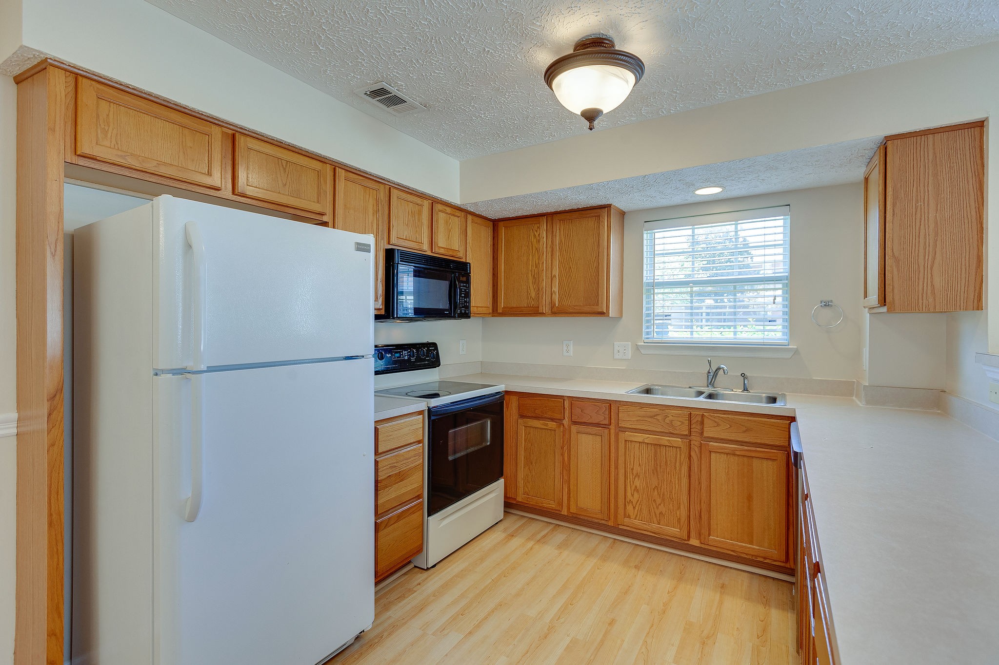 401 Compton Lane Franklin, TN 37069 - Photo 7 of 19 a kitchen with stainless steel appliances granite countertop a refrigerator a sink dishwasher a stove with wooden cabinets and floor
