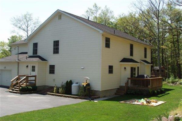 1562 Bush Road Cresco, PA 18326 - Photo 3 of 30 a front view of a house with a garden and trees