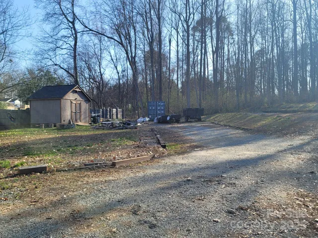 a backyard of a house with lots of green space and fountain