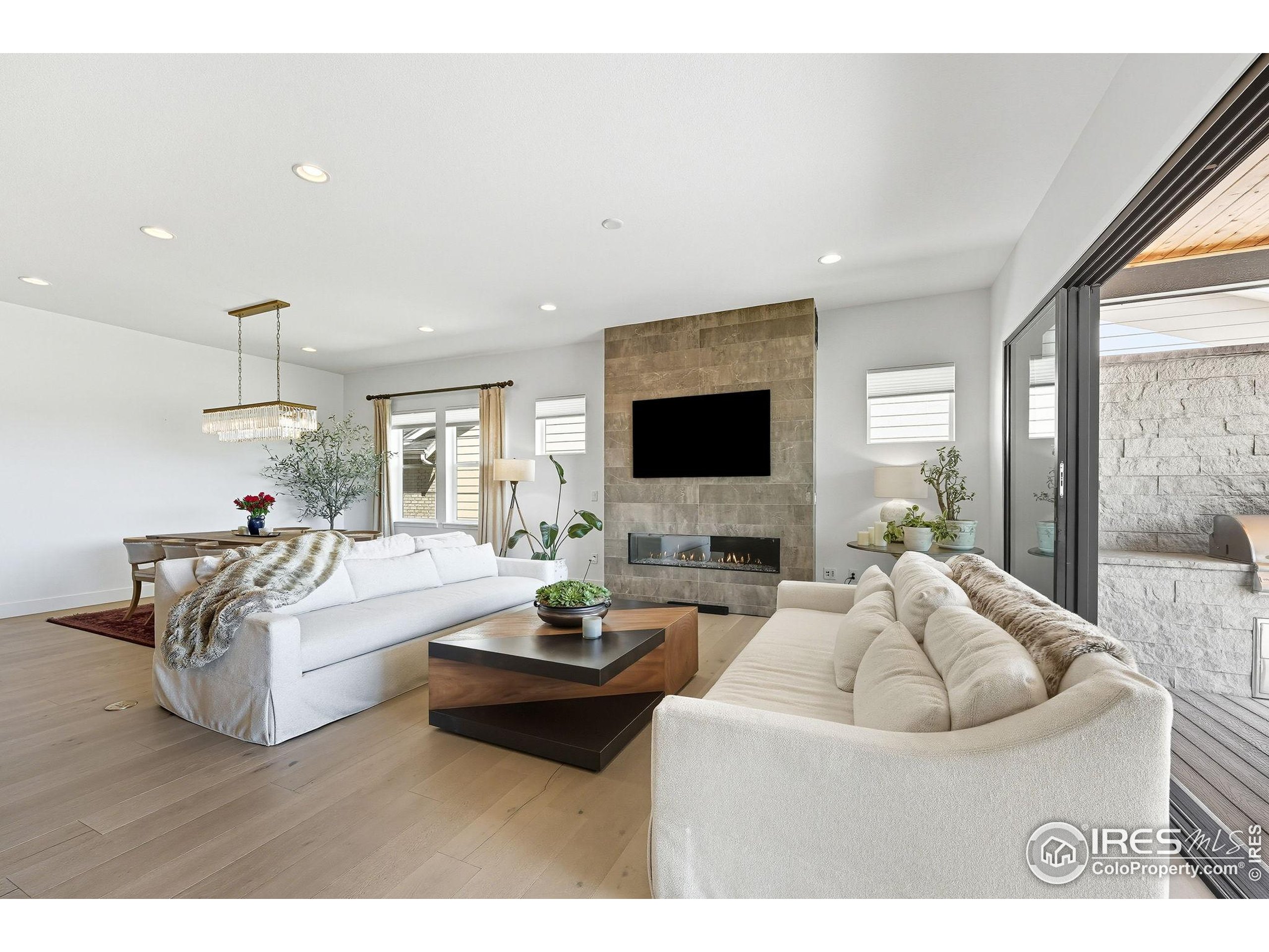7382 Canyonpoint Road Castle Pines, CO 80108 - Photo 13 of 49 a living room with furniture and a flat screen tv