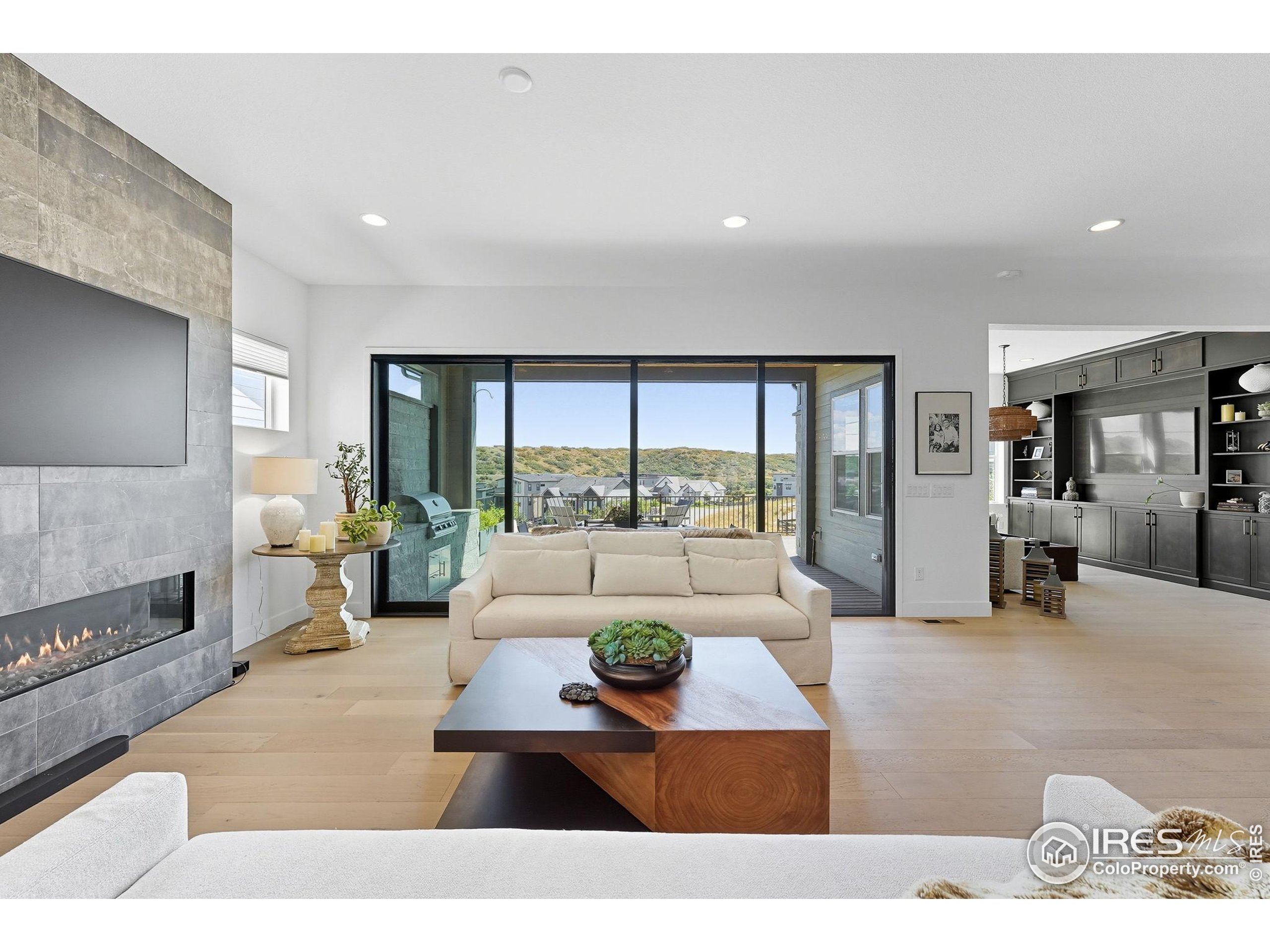 7382 Canyonpoint Road Castle Pines, CO 80108 - Photo 15 of 49 a living room with furniture and a large window
