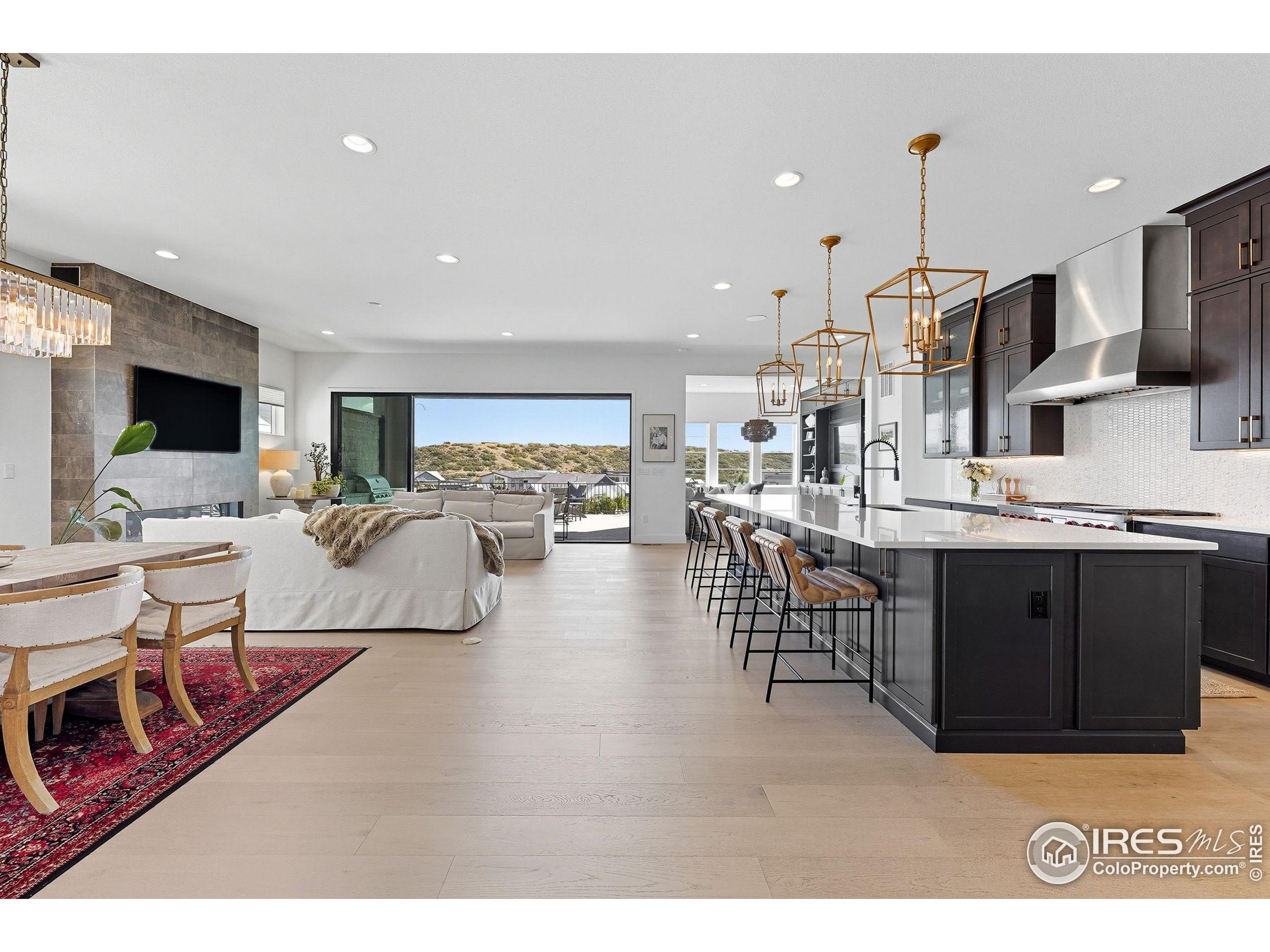 7382 Canyonpoint Road Castle Pines, CO 80108 - Photo 3 of 49 a living room with lots of furniture and kitchen view