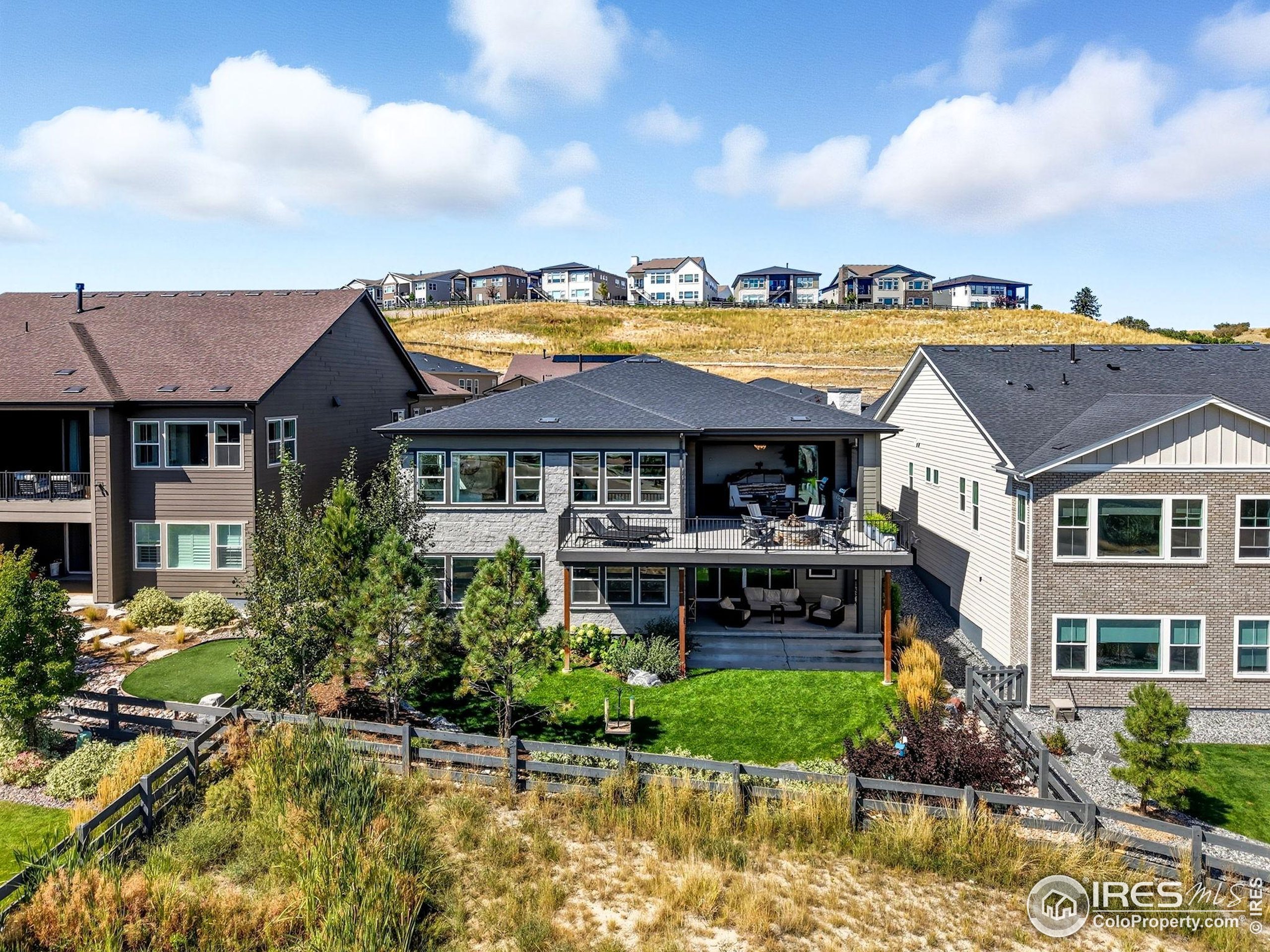 7382 Canyonpoint Road Castle Pines, CO 80108 - Photo 8 of 49 a front view of a house with a garden and swimming pool